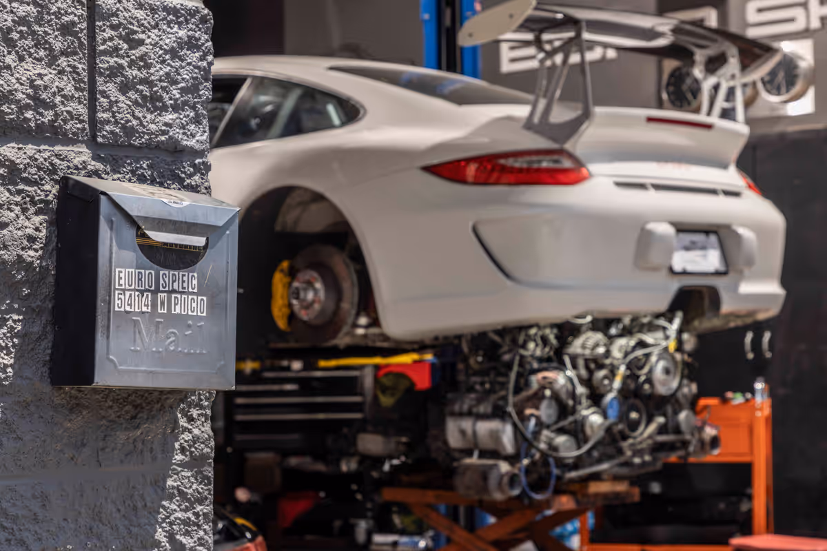 Porsche raised in a Euro Spec Motoring service bay for inspection