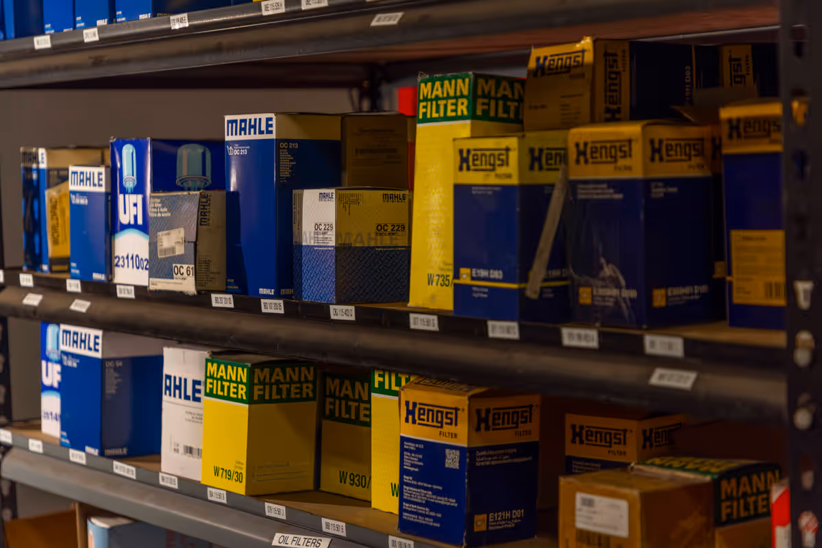 Oil filters and maintenance parts on shelves inside the workshop
