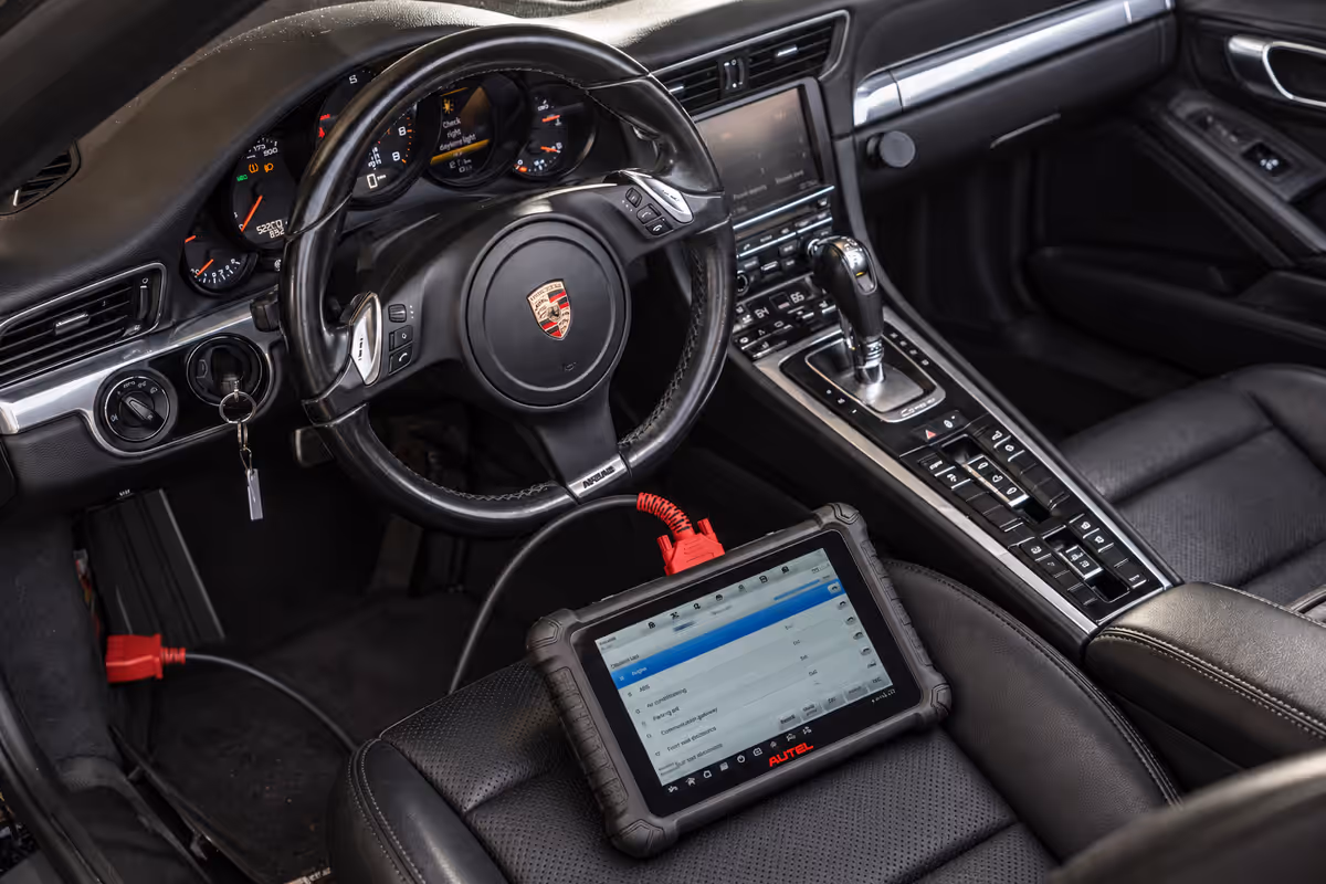 Diagnostic tablet connected inside a Porsche cabin